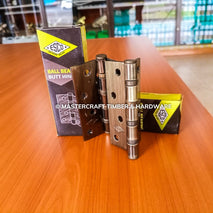 Brass ball bearing butt hinge with ESCO packaging on a wooden surface